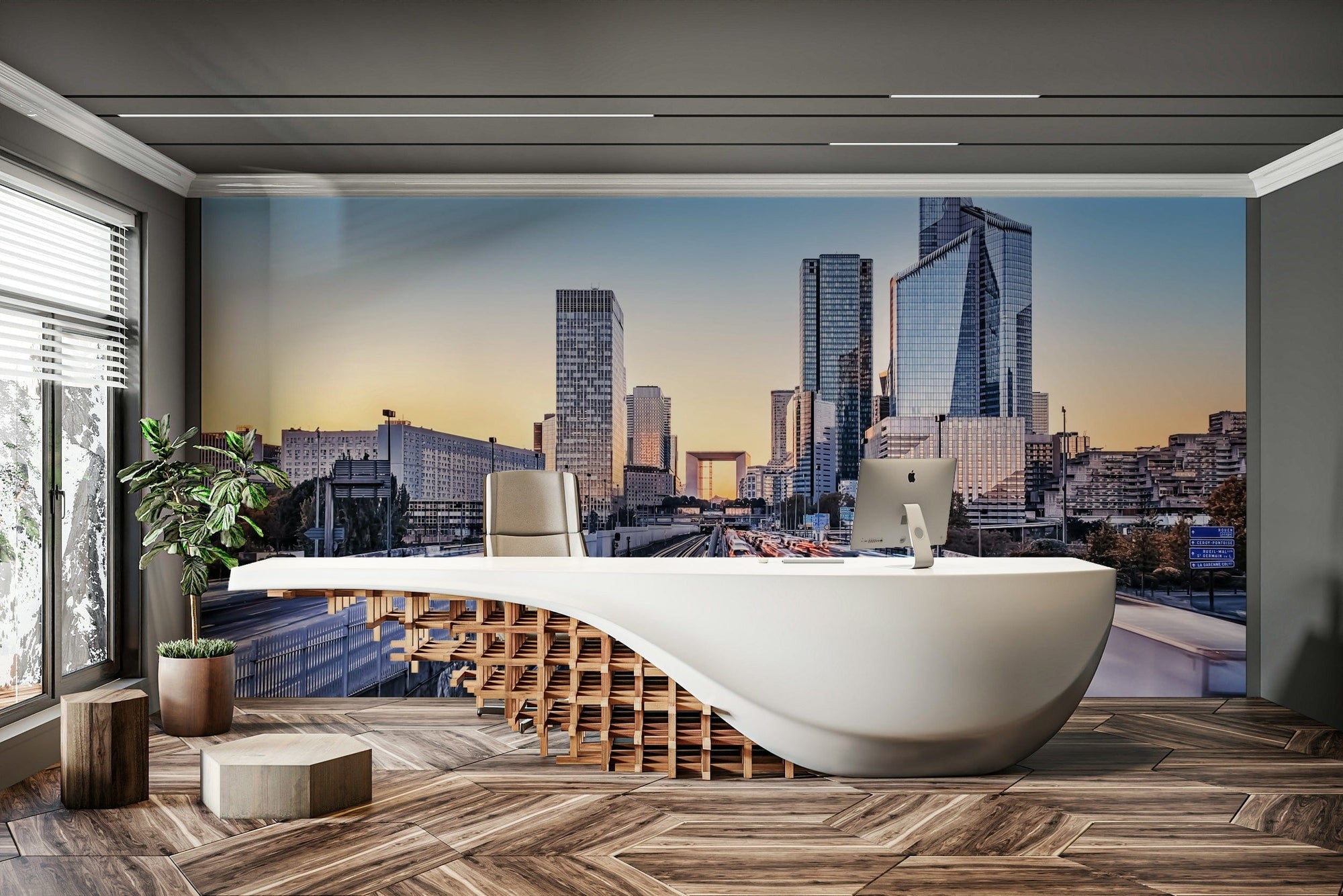 Metropolis Dawn wallpaper mural of a dawn skyscraper skyline and highway behind a curved white reception desk with an iMac