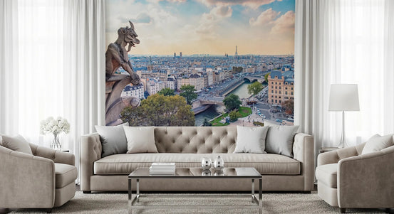 Parisian Guardian wallpaper mural with Notre-Dame gargoyle over Paris behind a beige tufted sofa in a living room