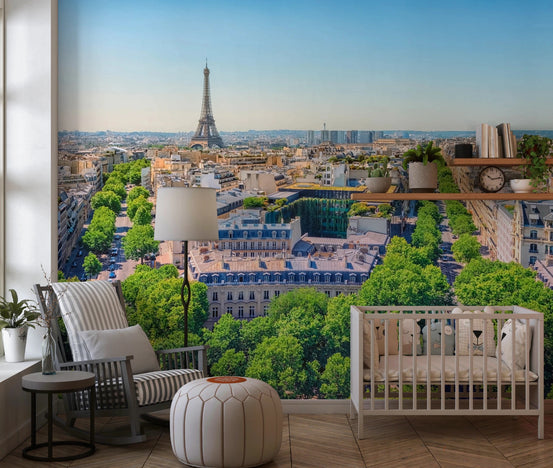 Parisian Heights wallpaper mural of an aerial Paris skyline with the Eiffel Tower behind a striped rocking chair and white crib in a nursery