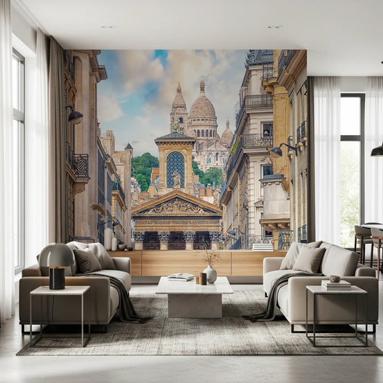 Parisian View wallpaper mural of Sacre-Coeur down a Haussmann street behind beige armchairs in a living room