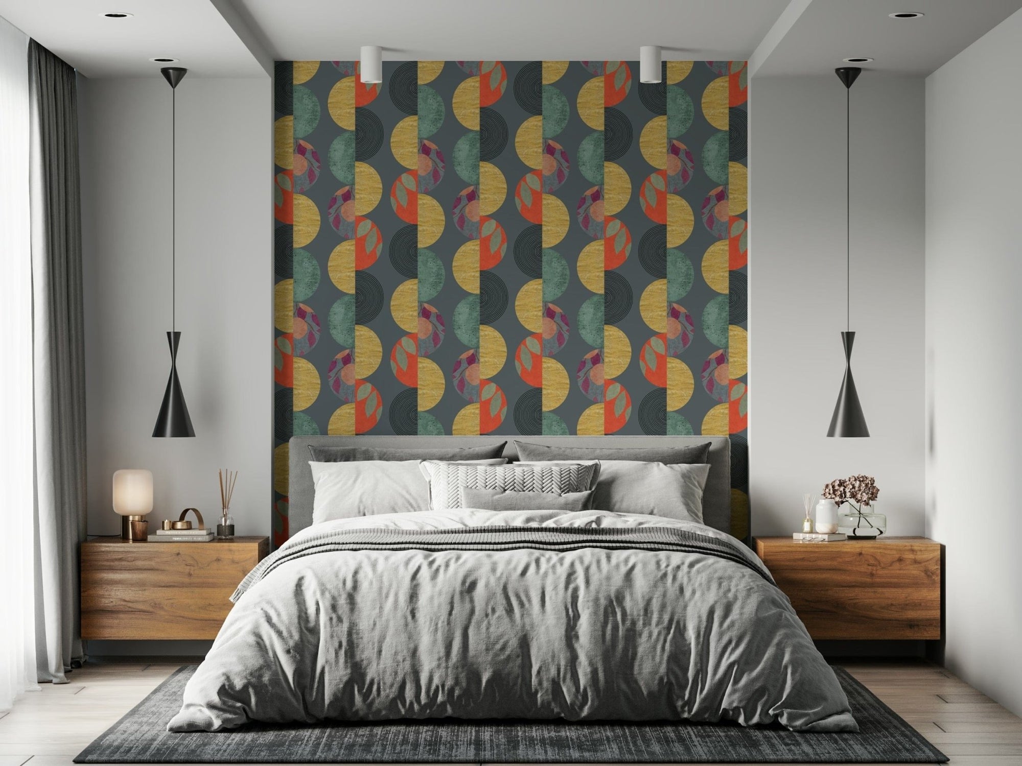 Party Wall wallpaper with gold and teal geometric circles behind a grey bed and walnut nightstands