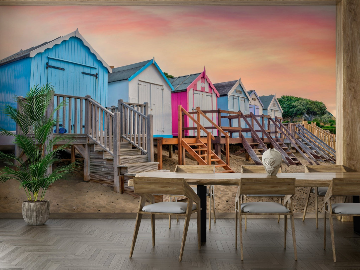 A wall mural of a row of pastel-colored beach huts.

