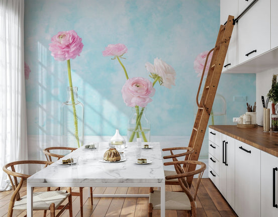 Pastel Ranunculus Glass Decor wallpaper mural with pink blooms in glass bottles behind a marble dining table in a kitchen