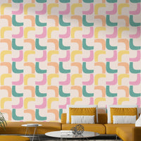 Mid-century modern wallpaper with pastel boomerang shapes in mint, pink, and yellow.

