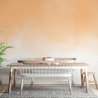 Artistic peach watercolor wallpaper for vibrant living room walls.