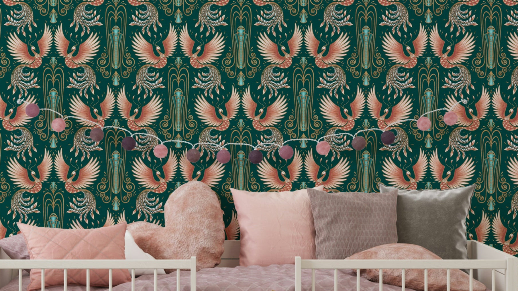 Rebirth of a Phoenix Green wallpaper with coral phoenix birds on teal behind a white crib and pink cushions in a nursery