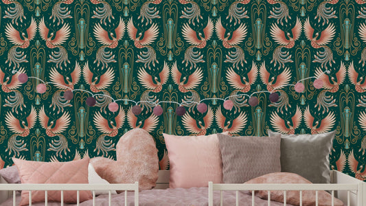Rebirth of a Phoenix Green wallpaper with coral phoenix birds on teal behind a white crib and pink cushions in a nursery