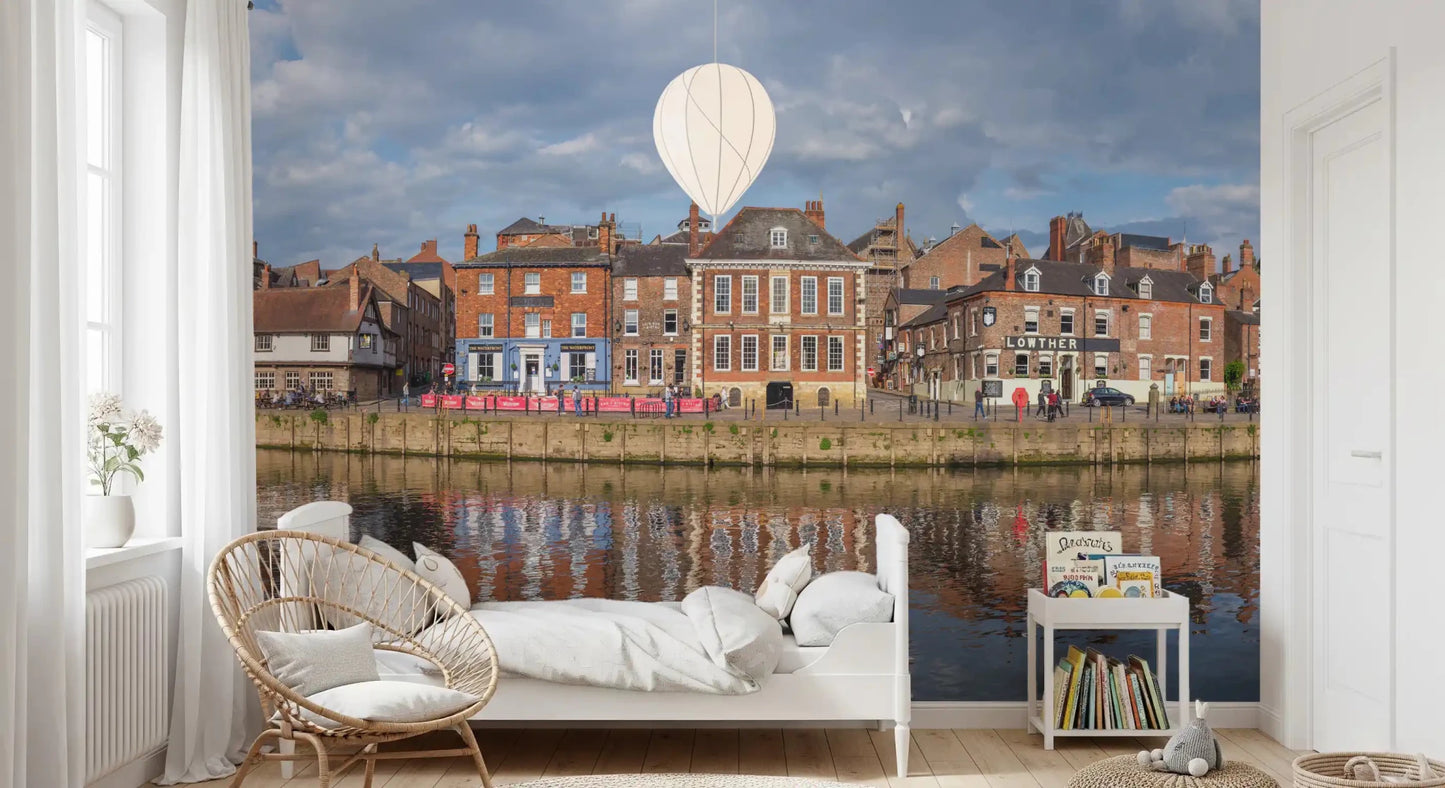 Picturesque Riverfront Wall Mural with historic brick buildings and water