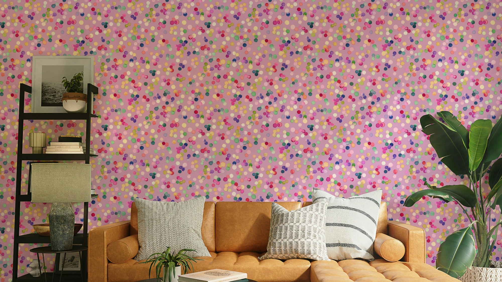 Confetti Festive Colorful Dots Pink wallpaper in a living room with a tan leather sofa and striped cushions