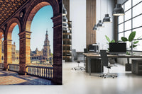 Plaza de España View wallpaper mural of the brick colonnade and tower beside grey desks in an open office