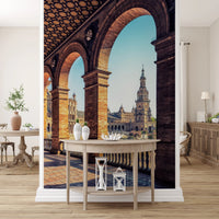 Plaza de España View wallpaper mural of the arched colonnade and plaza above a pale wood console in an entryway
