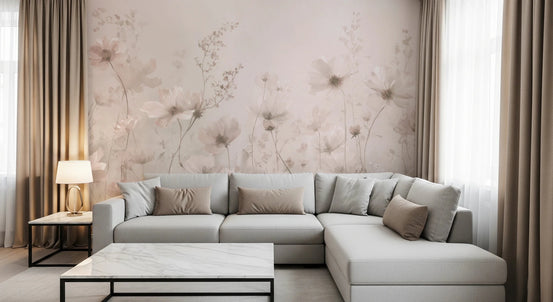 Poetic Soft Floral Petal Dust wallpaper mural of blush cosmos flowers in a living room with a grey sectional sofa