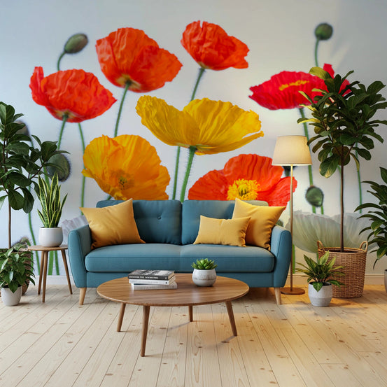 Poppy Field Burst wallpaper mural of red yellow and orange poppies behind a teal sofa with yellow cushions in a living room
