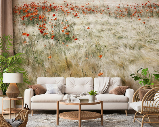 Poppy Field Dreams wallpaper mural of red poppies in a pale grass field behind a cream sofa and rattan chair