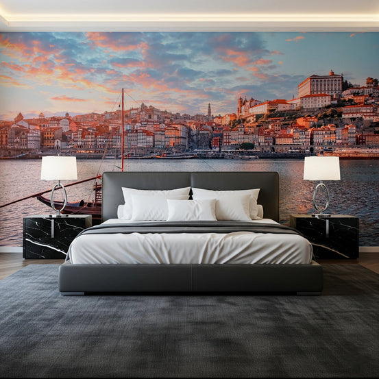 Porto Sunset Glow wallpaper mural of the Douro riverfront at dusk behind a grey bed and black marble nightstands