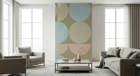 Soft sage and pink shapes form a chic wall mural design.
