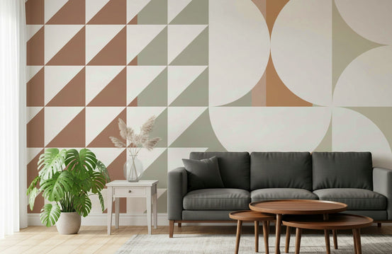 Retro Harmony wallpaper mural in terracotta and sage geometric shapes behind a charcoal sofa and nesting tables