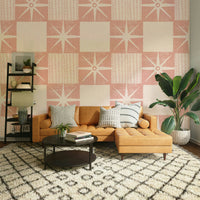 Minimalist mid-century pink starburst wallpaper design

