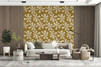 Vintage-style wallpaper showcasing radiating floral bursts on a textured mustard backdrop.