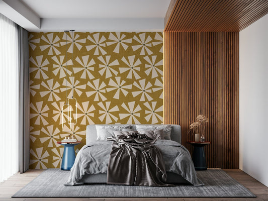 Retro sunburst bloom wallpaper featuring cream starburst flowers on a mustard yellow background.