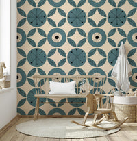 Teal-toned geometric wallpaper with alternating circles and leaf clusters in a mid-century style.