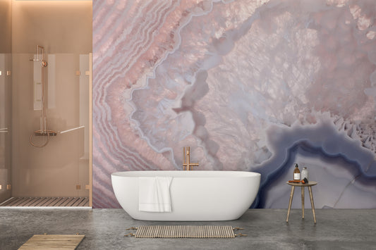 Rose Pink Geode wall mural of banded pink and lavender agate behind a white bathtub in a modern bathroom