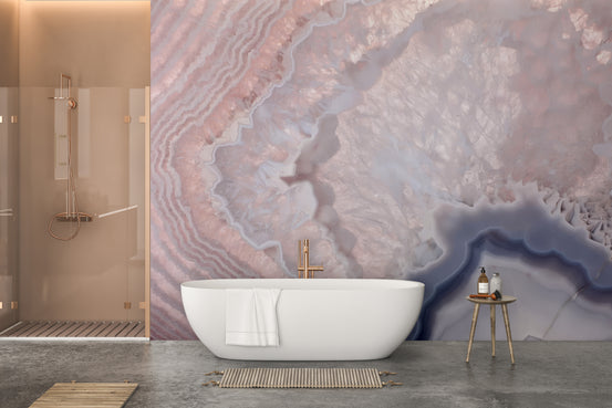 Rose Pink Geode wall mural of banded pink and lavender agate behind a white bathtub in a modern bathroom