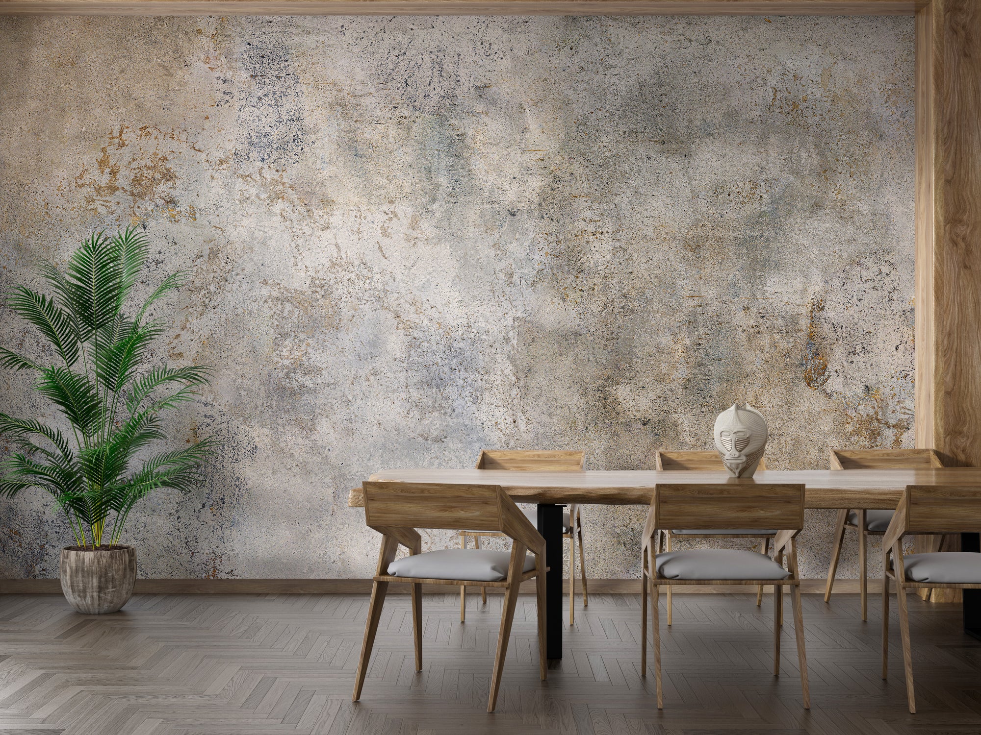 Rustic Gray Cement Texture wallpaper mural with tan patina behind a wood dining table and tall potted palm