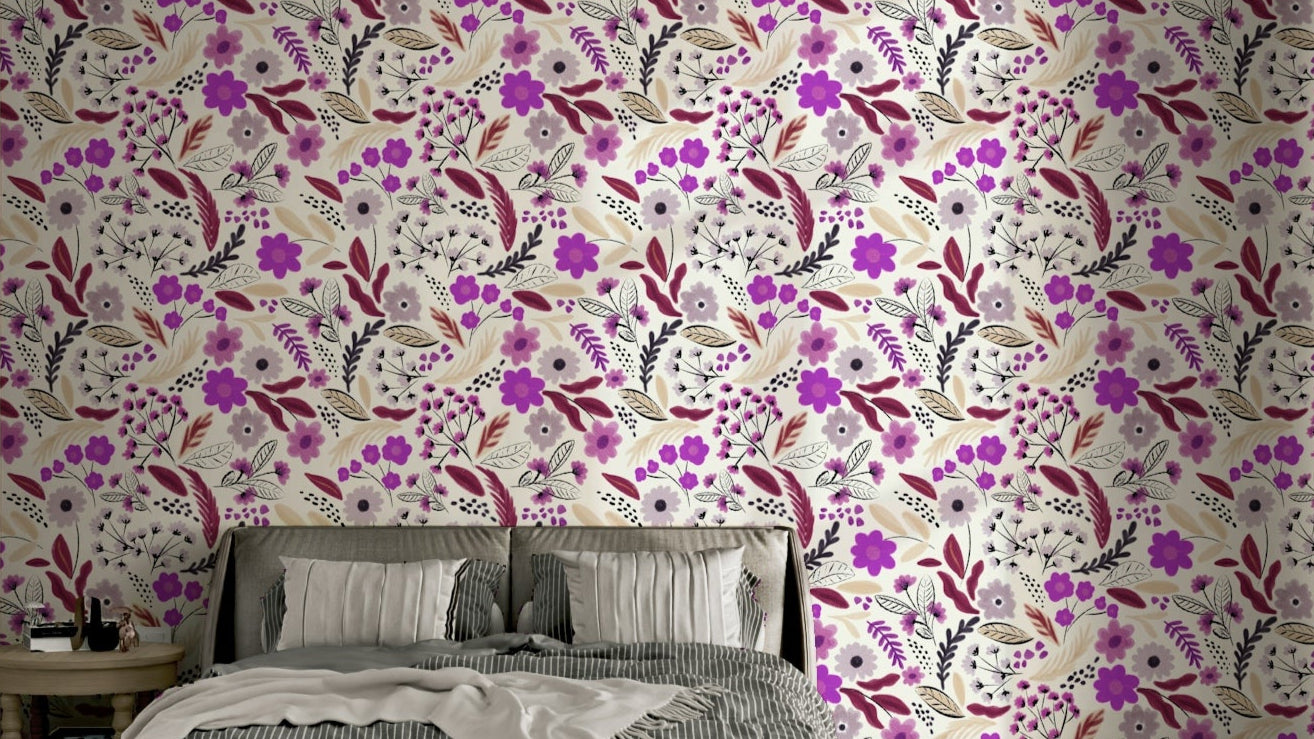 Rustic Rose Garden botanicals wallpaper in magenta and burgundy on cream behind a bed with grey striped pillows