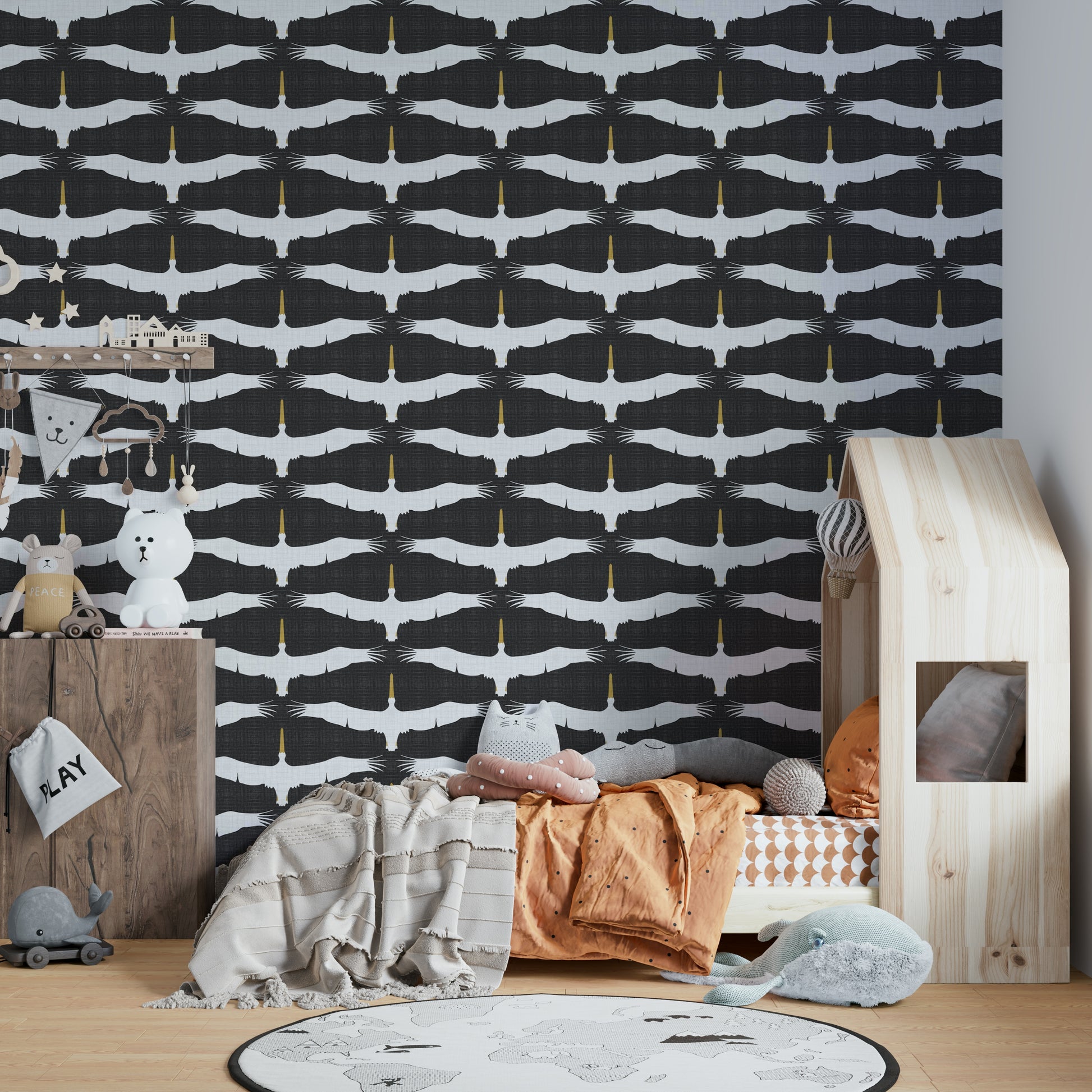 Graceful spoonbills flying across muted gray backdrop

