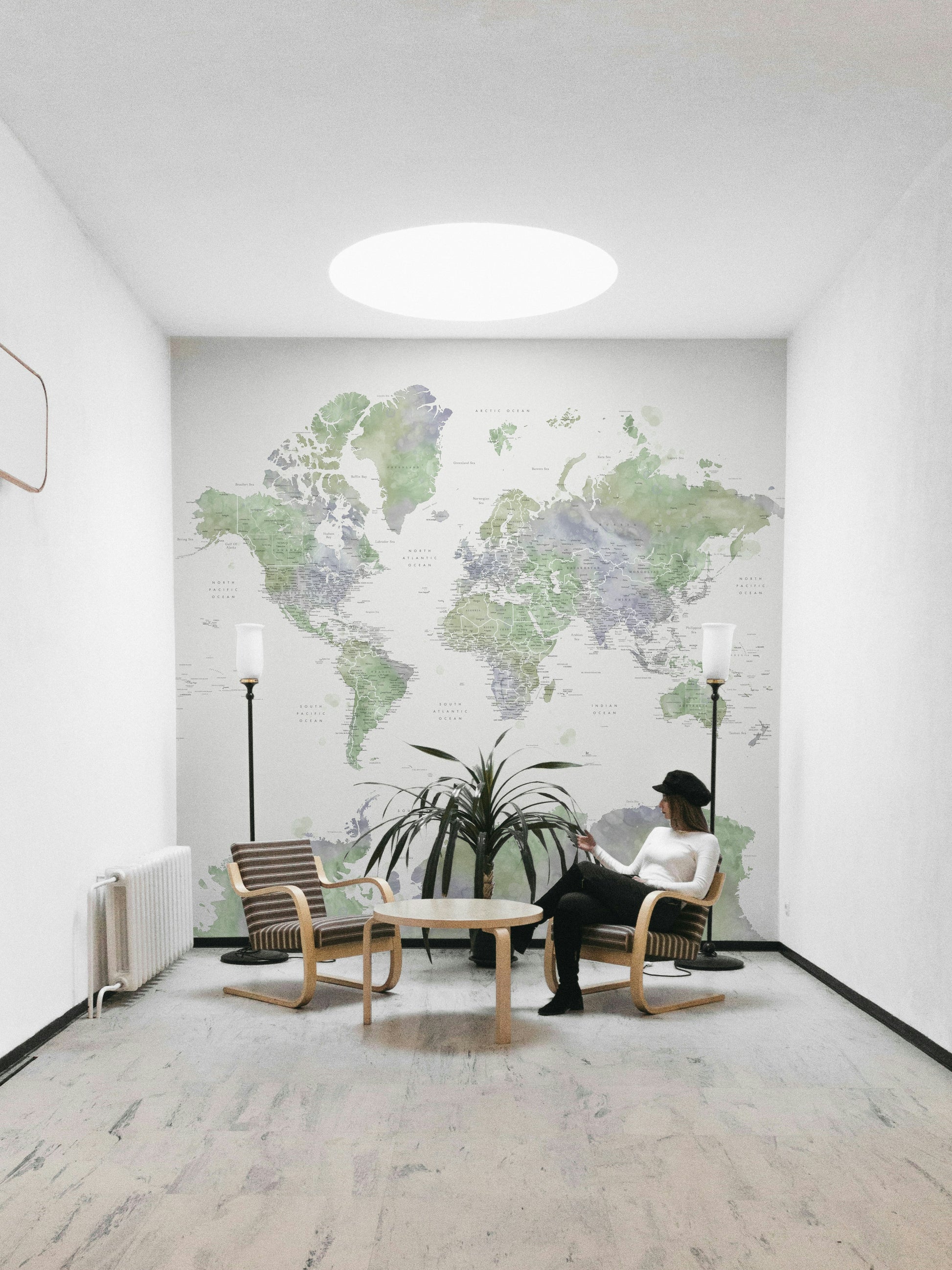 Serene world map mural in light sage tones

