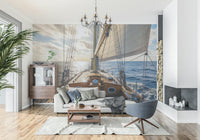 Coastal sailboat mural behind beige sofa, blue and white wall decor for apartment