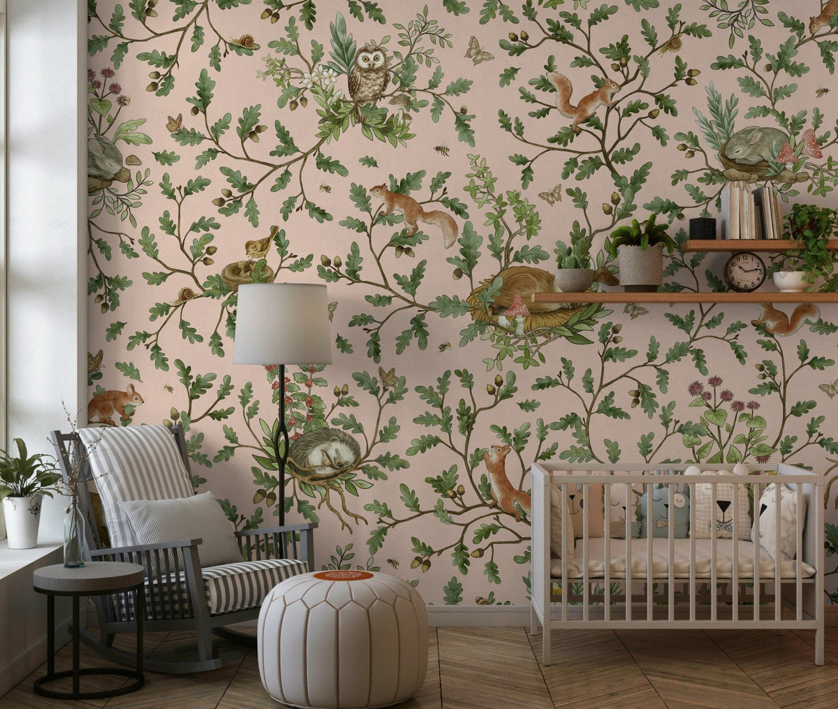 Secret Grove wallpaper mural with blush-pink woodland of owls and squirrels in a nursery with white crib and rocking chair