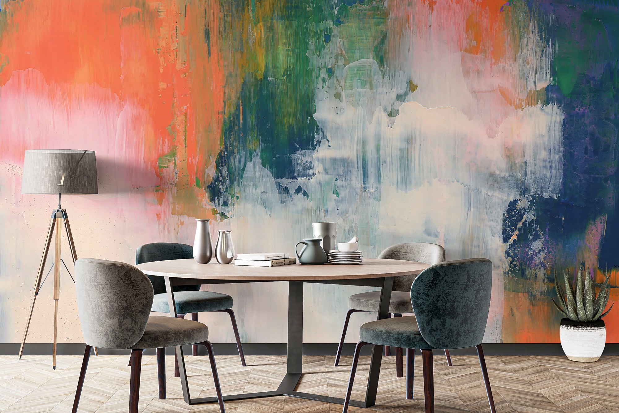 Abstract Brushstroke wallpaper mural in coral, green and blue behind a round wood dining table with grey chairs