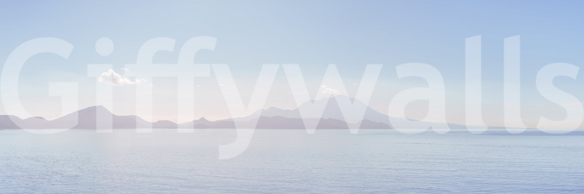 Ocean landscape with rocks and a sandy shore.

