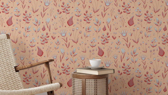 Serene Peach Tropical Garden wallpaper behind a woven cane lounge chair and round rattan side table