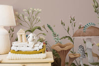Premium canvas Mushroom Garden Wall Mural in a nursery room with a wooden stool and cute plushies for a high-end feel.