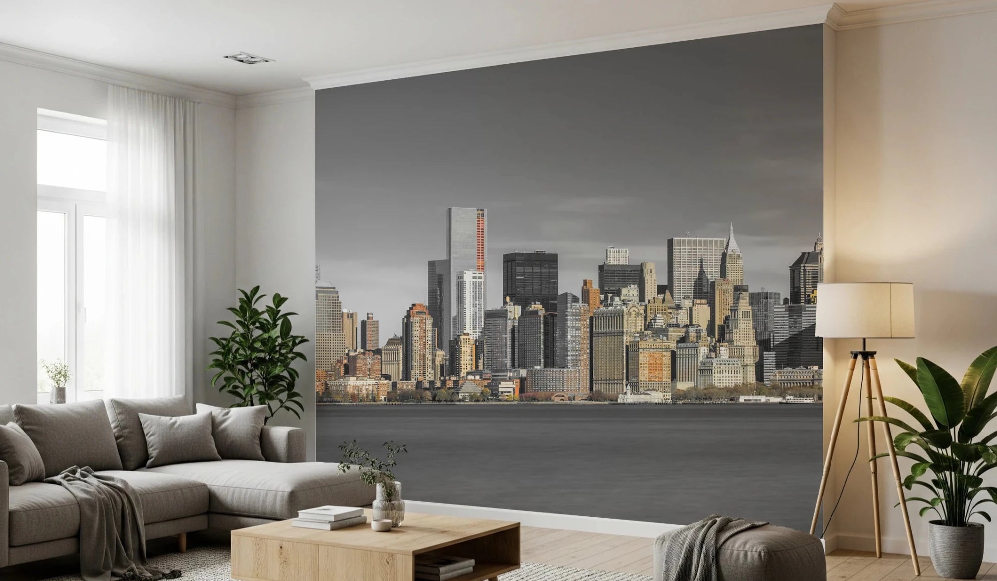 Skyline of New York City mural over a gray sectional sofa and wood coffee table in a living room