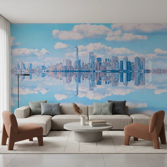 Skyline Reflection wallpaper mural of the New York skyline mirrored in water above a beige sectional and rust chairs