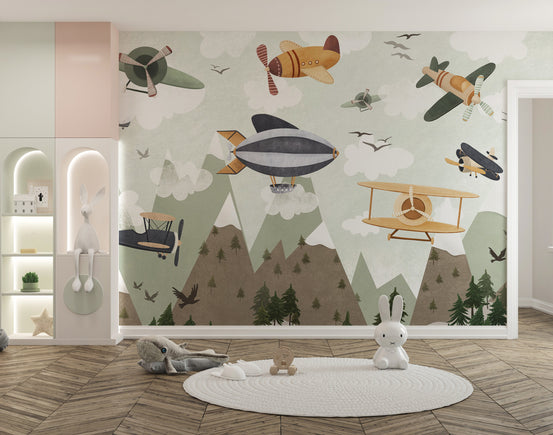 Skyward Adventure wallpaper mural with vintage planes and a grey airship over pine mountains in a kids room with a white bunny figurine