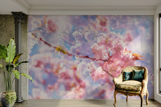 Soft Pink Blossoms wall mural of cherry flowers on blue sky beside an ornate column and a floral antique armchair