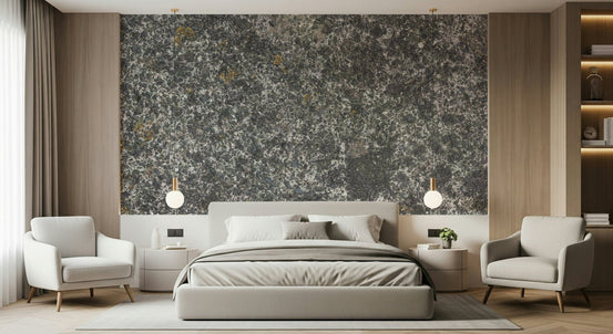 Speckled Stone Texture wallpaper mural above a grey bed flanked by two white armchairs and globe pendants