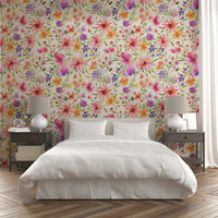 Floral wallpaper featuring pink, yellow, and lavender dahlias with playful vines.

