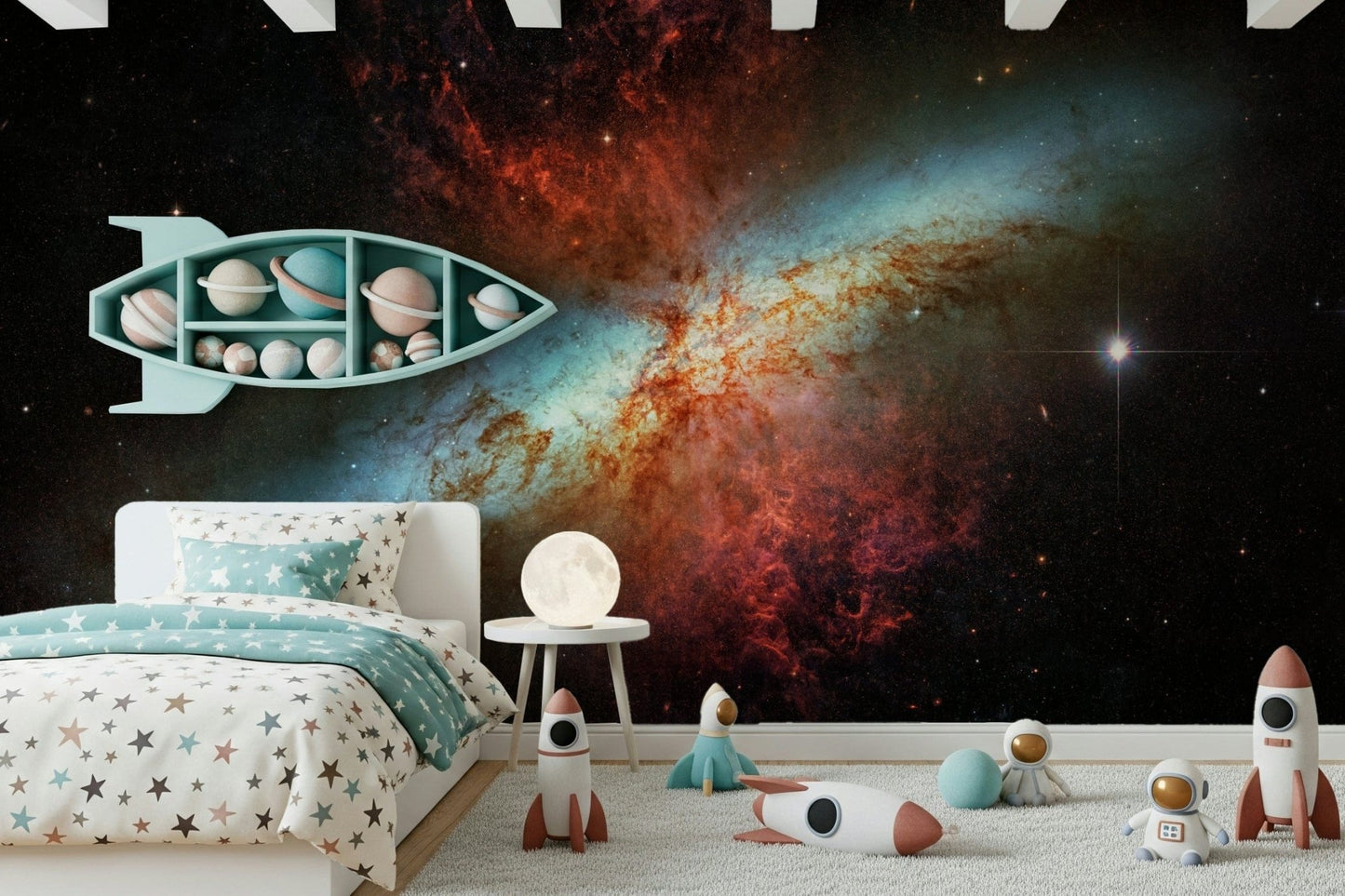 Stardust Symphony wallpaper mural with a cosmic starburst in a kids room with a teal rocket shelf and star bedding