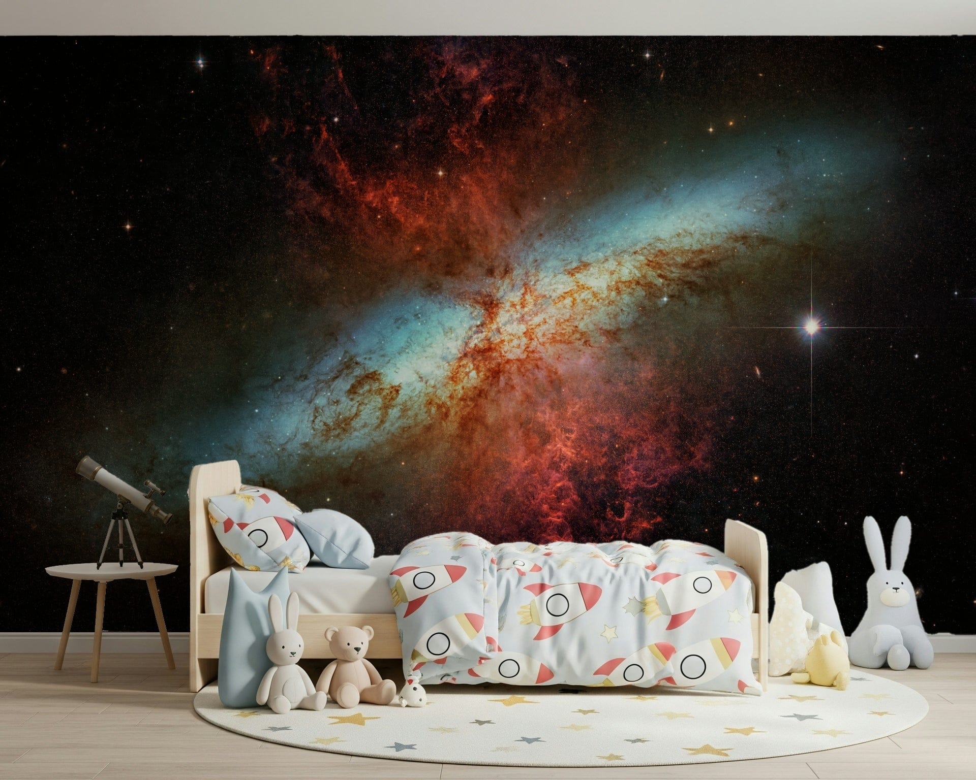Stardust Symphony wallpaper mural of a fiery starburst in a kids bedroom with a telescope and rocket-print bedding