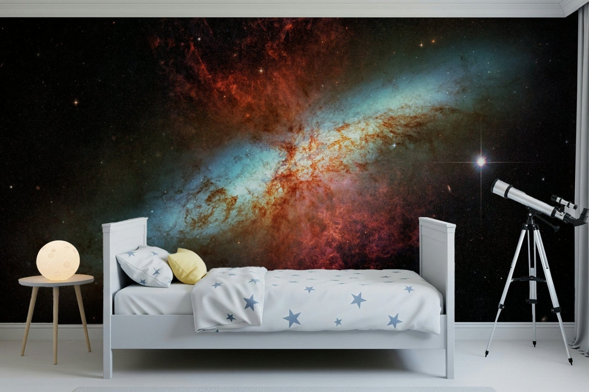 Stardust Symphony wallpaper mural with a red and turquoise nebula in a kids bedroom with a telescope and moon lamp