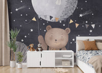 Starry night wallpaper mural featuring a bear holding a balloon.
