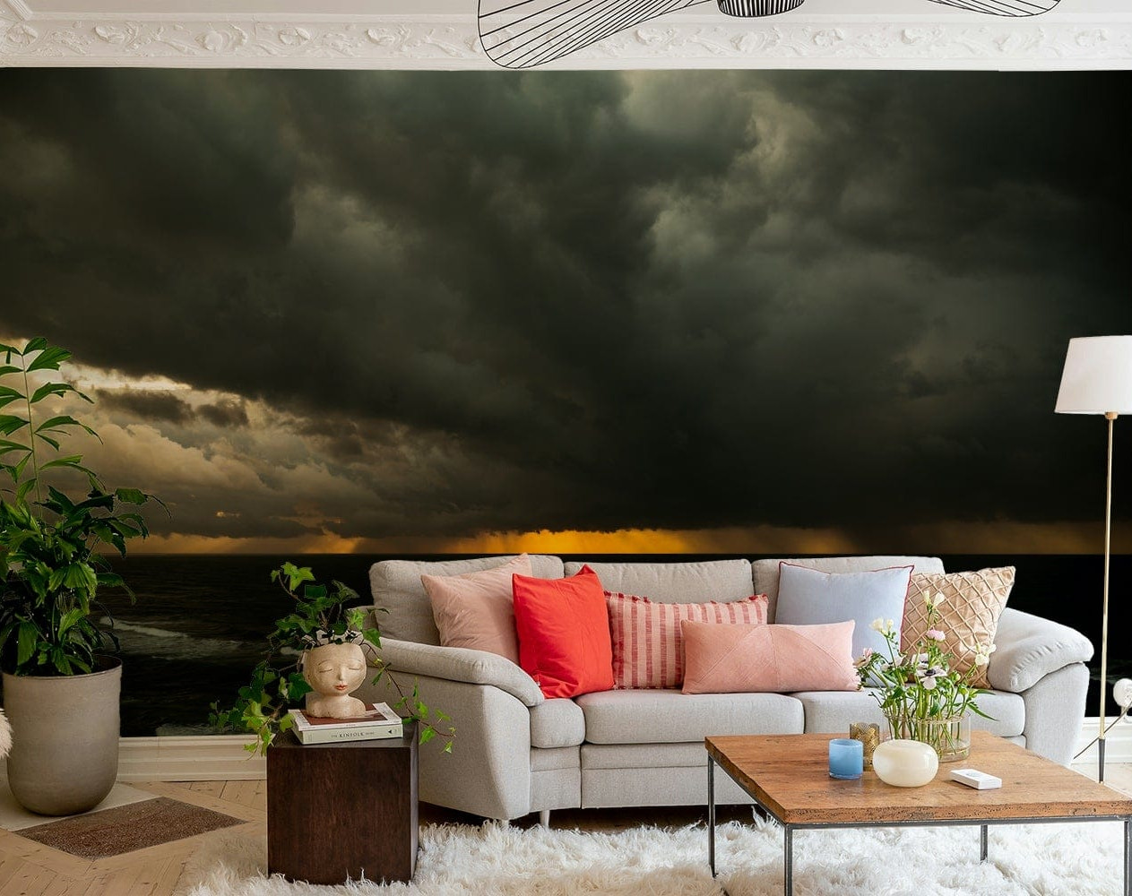 A bedroom with the artistic mural behind the headboard.

