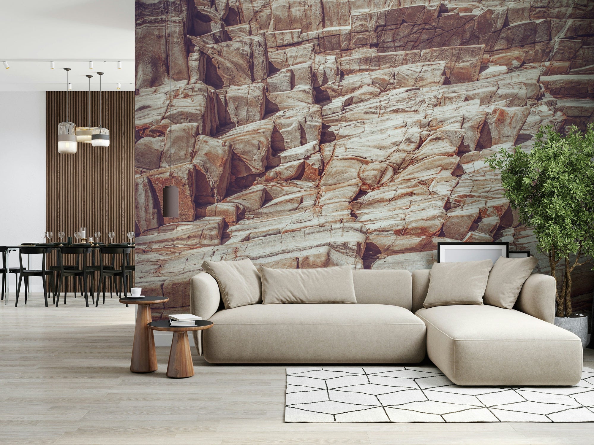 Striated Rock Face wallpaper mural of layered red and cream stone behind a beige sectional sofa in a living room