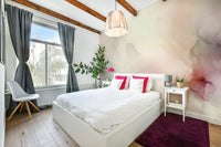 Minimalist pink and cream wave wall covering for a stylish and bright guest bedroom.